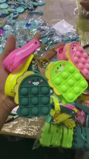 Monedero circular de silicona para niños de color pastel con diseño de dinosaurio